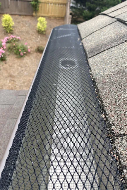 Top view of a gutter with a mesh guard installed by Whitaker Roofing in Douglasville, GA.